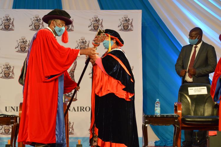 Prof. Kiama receiving the University of Nairobi maise symbol of our scholarly integrity