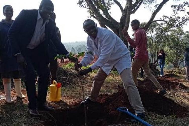 Dr. George Abong' leads the department in the tree planting exercise