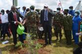 The VC, UoN watering the tree he had planted 